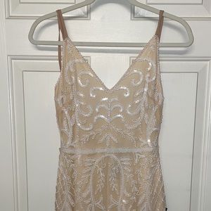 Nude fitted dress with bead design.